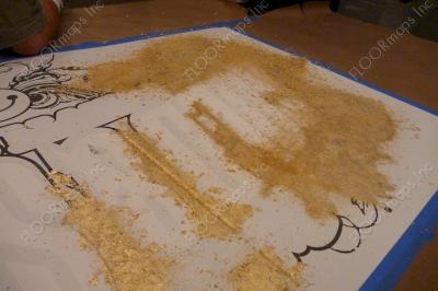 Second layer of our 3.4 mil vinyl stencil has been applied and gold flake has begun to be rubbed into the exposed areas.