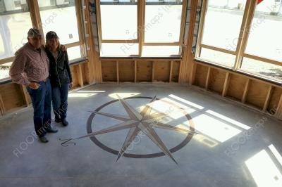 Compass Rose installed with muted brown colors on a low grit polished concrete floor using 3.4 mil vinyl stencil.
