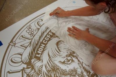 Removing transfer tape of the second right panel of layer 1 for the Lion Coffee logo.