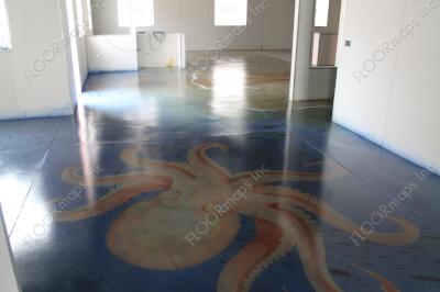 Full image of installed orange octopus surrounded by blue on a polished concrete floor using dye and 3.4 mil vinyl finished with sealer