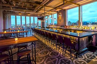 Picturesque side view of the geometric floor pattern installed in front of the hotels rooftop bar overlooking the NY skyline mid cloudy day.