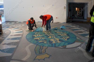 Ameripolish Dye has been fully applied and 3.4 vinyl stencil proceeds to be removed revealing a colorful floor.