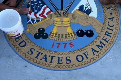 US Army Seal on light gold microtopping circle and blue, yellow, black, red, gold, and white spray paint mid install touching up with 3.4 mil vinyl stencil and Deco Guard sealer