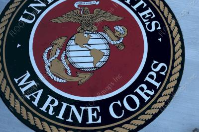 US Marine Corp Seal on black microtopping circle and gold, red, and white spray paint installed with 3.4 mil vinyl stencil and Deco Guard sealer